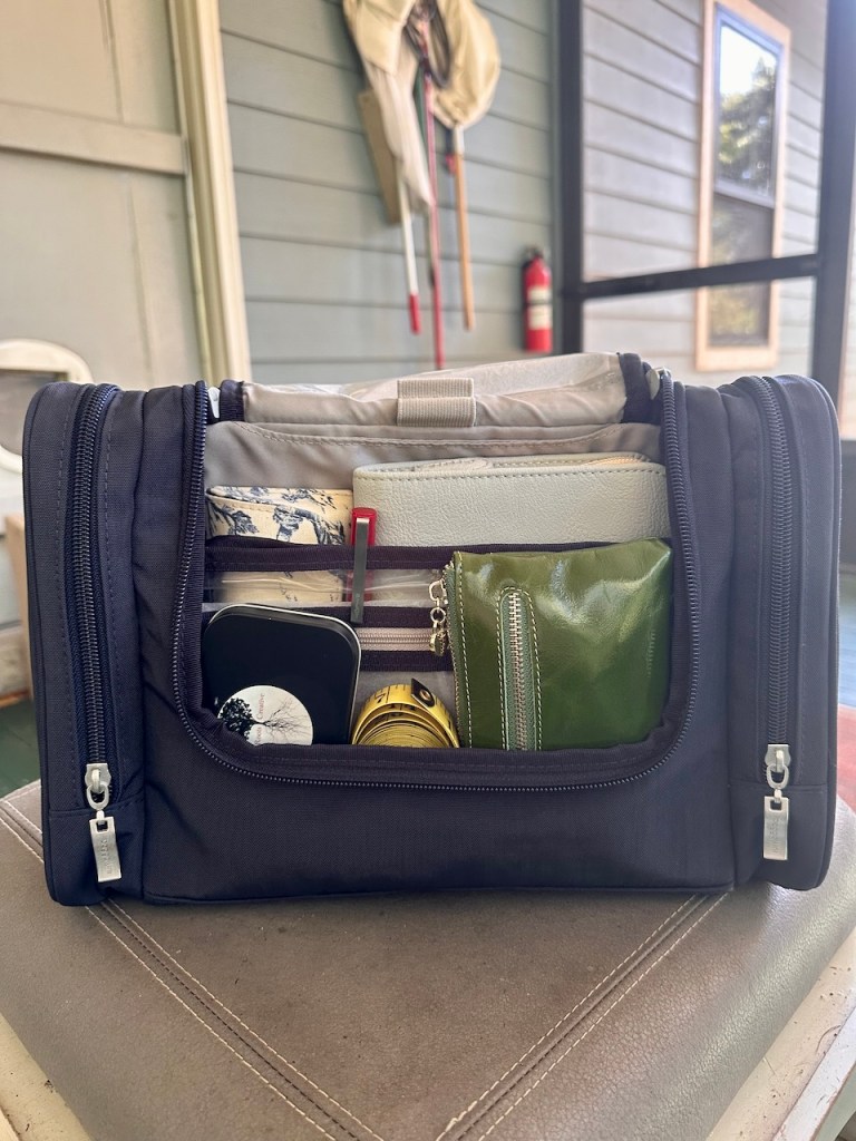 Dark blue toiletry bag filled with various tools for crafting.
